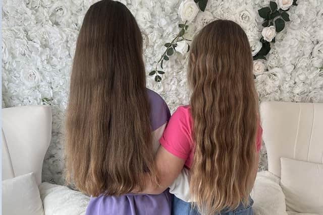 Freya and Sofija with their long hair before the cut. Photo: Submitted