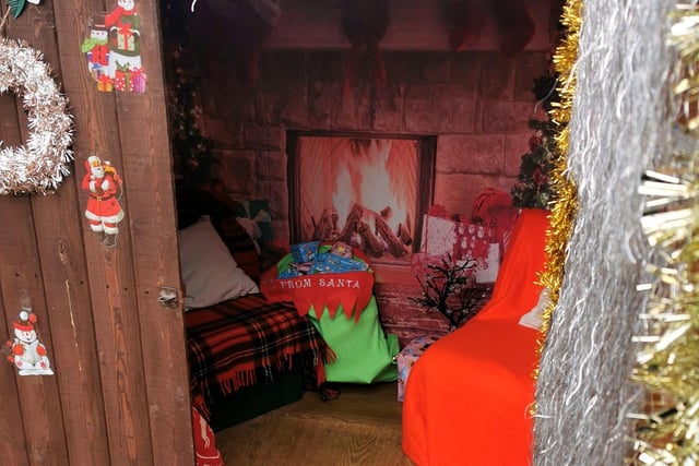 Children visited Santa in his shed.