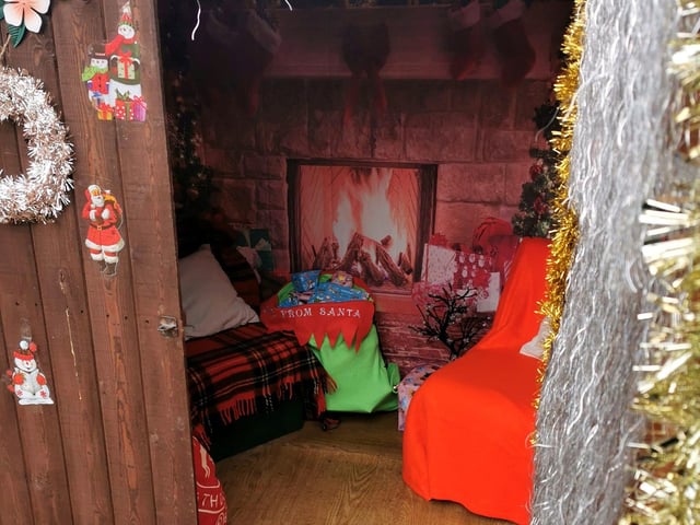 Children visited Santa in his shed.
