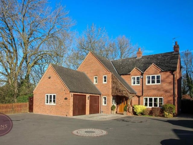Time to move back outside now, starting at the front of the £700,000-plus house. A large, tarmac driveway, with turning circle, provides off-street parking space and leads to a double garage that has up-and-over doors, power and a sink.