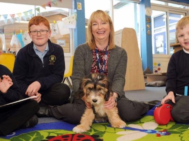 Head teacher Helen Thomas in 2018 with year 6 pupils Euan and Elliott and Leo who all benefitted from having Dooley, Mrs Thomas' Cockerpoo join the team.