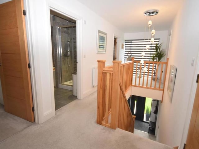 At the top of the stairs is this galleried landing, which guides you to all five bedrooms. A picture window at the front floods the whole of the first floor with natural light, while a walk-in cupboard offers lots of storage space.