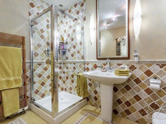 The shower room on the ground floor features a corner shower cubicle, splash tiling, a pedestal hand wash basin, a foot wash basin and a low-flush WC.
