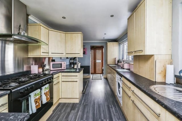 Next stop at the Larch Crescent bungalow is the busy breakfast kitchen. Appliances include a free-standing multi-fuel cooker with hood and an integrated dishwasher, while there is space and plumbing for a washing machine.