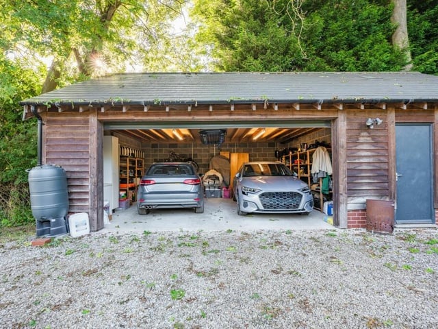 Talking of off-street parking space, the double garage, which is fitted with electric doors, can also accommodate two vehicles. It has space for storage and a workshop too.