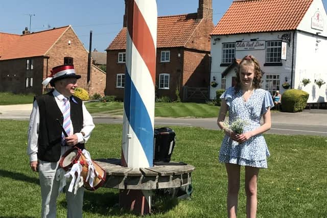 May Queen-elect Ellie Wilson and local musician Tony Wade at Wellow Maypole