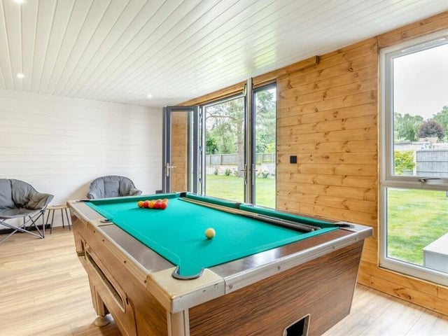 A pool table occupies the garden room at present, but the space is so flexible. It boasts a wood-effect laminate floor, six ceiling spotlights, French doors at the front and three external spotlights.
