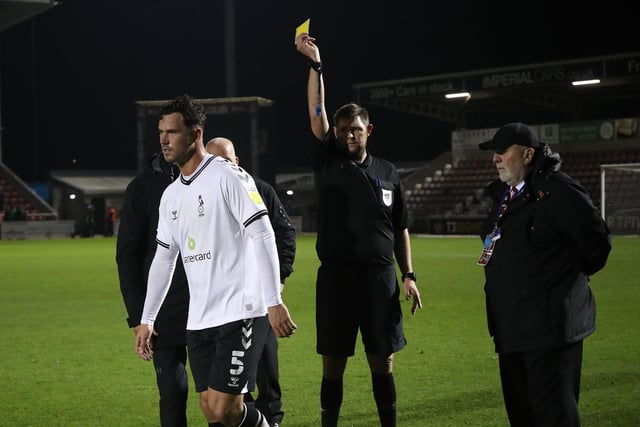 Harrison McGahey is shown a yellow card by referee Brett Huxtable at the the final whistle. Oldham had 79 bookings and three reds.