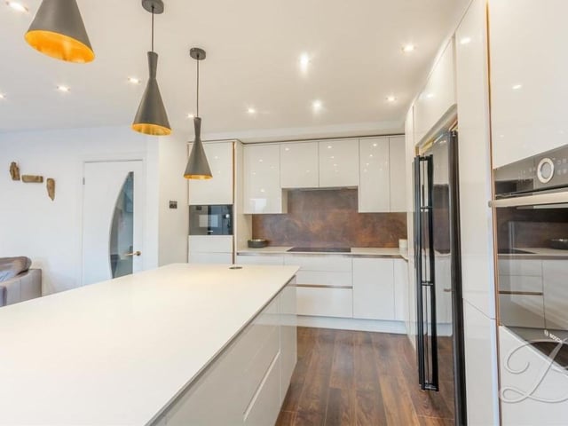 Back to the heart of the kitchen, where integrated appliances include a double oven, microwave and wine cooler. There is also space and plumbing for an American-style fridge/freezer.