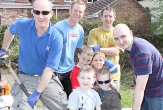 Volunteers and pupils help create a new path at Hollywell Primary School in Kimberley.