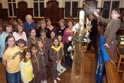 Abbie Kingswood, right, a member of St Augustine's Brownies, lit the SHINE Tree of Lights' candle at a special ceremony at Mansfield's Queen Elizabeth's School.
