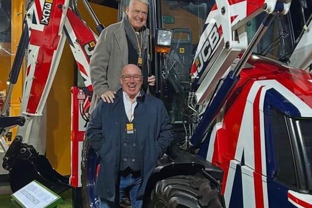 Lee Anderson MP and Council Leader Mick Barton on a union flag themed JCB.