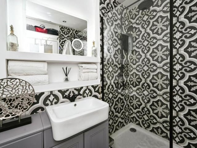 The luxurious, three-piece shower room offers both convenience and elegance. Its well-designed fixtures and fittings create a spa-like ambience.