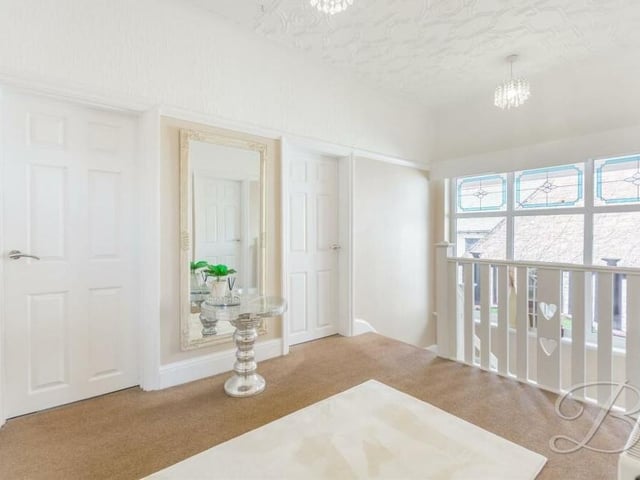 At the top of the stairs, you are greeted by this first-floor landing, which guides you to all five bedrooms.