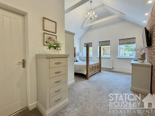 The magnificent master suite serves as a luxurious private retreat, benefitting from a contemporary en suite shower room.