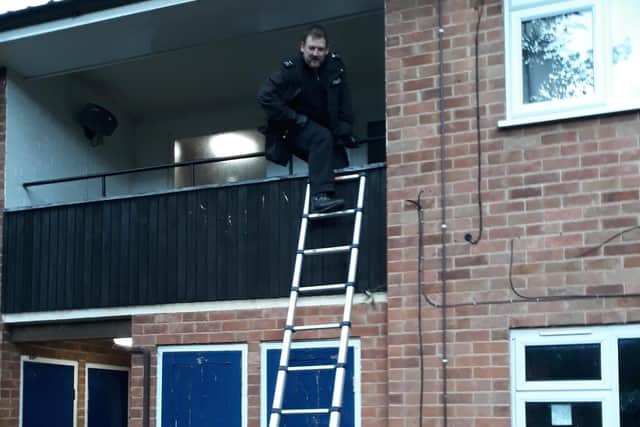 Two officers scaled the balcony of the property