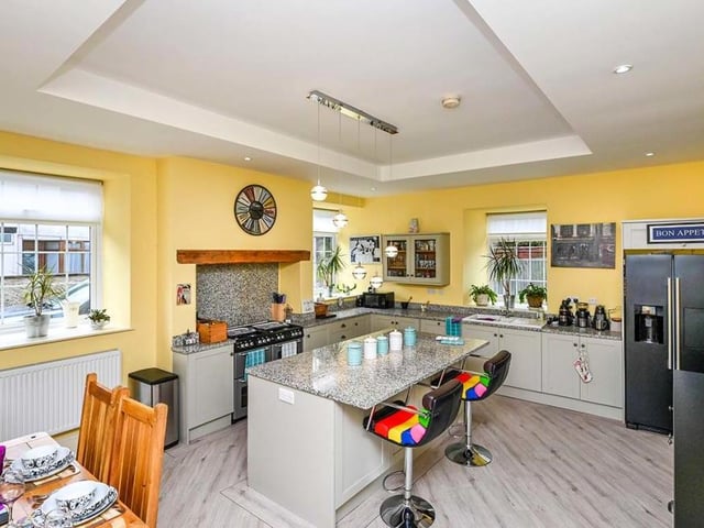 The kitchen/dining room is a spectacular sight, with a modern range of units and an island taking centre stage. Integrated appliances include a New World Aga-style range cooker, a dishwasher and a concealed Worcester combination boiler, fitted in 2019. The flooring is Karndean and there are windows to the front and side of the cottage.