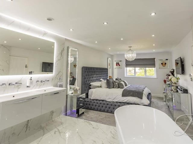 A photo, taken from the en suite, that shows the true extent of the glitz and glamour in the master bedroom.