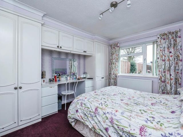 Here is the second of the main double bedrooms, which features dressing-table space, as well as the fitted wardrobes and storage space.