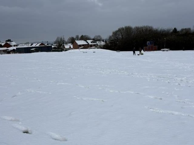 Snow lying deep and crisp and even on an Underwood park.