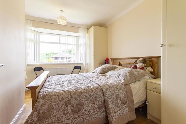 Two of the four bedrooms at the dormer bungalow can be found on the ground floor, including this one. It contains two fitted single wardrobes and matching bedside cabinets, while the large bay window faces the front of the property.