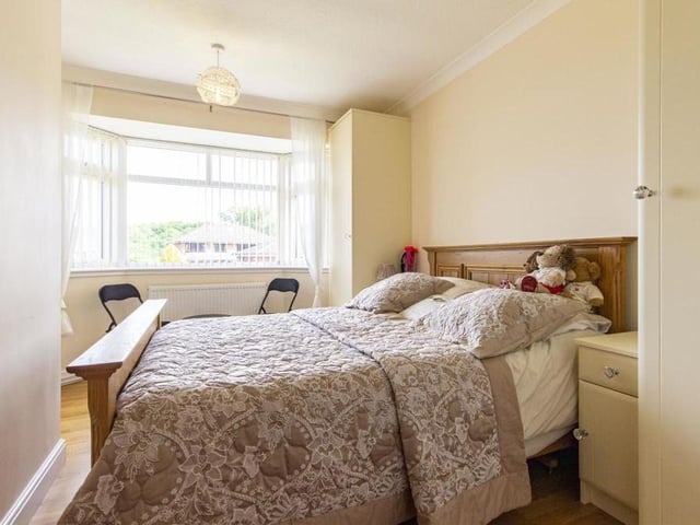 Two of the four bedrooms at the dormer bungalow can be found on the ground floor, including this one. It contains two fitted single wardrobes and matching bedside cabinets, while the large bay window faces the front of the property.