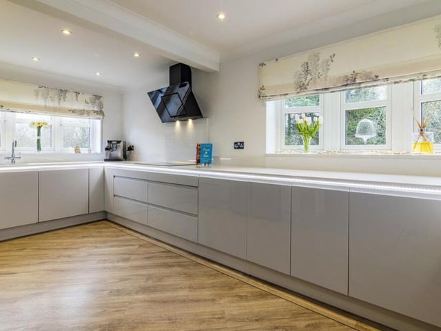 The spacious kitchen is equipped with top-of-the-line appliances and sleek cabinetry.