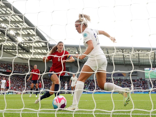 Lauren Hemp scores England's second goal under pressure from Maren Mjelde.
