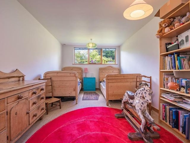 The rocking horse and teddy bear give the game away here. This bedroom is perfect fir the kids, with space for two single beds.
