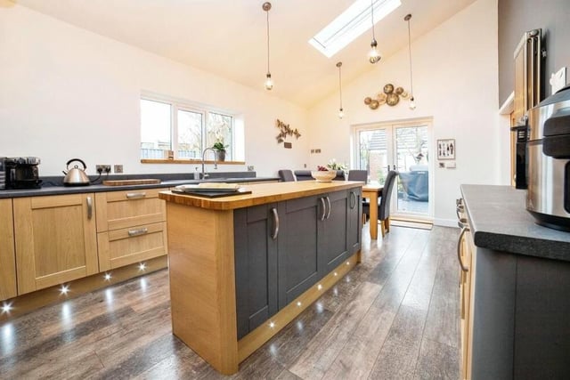 Sitting alongside the lounge at the back of the bungalow is this sparkling dining kitchen. How do you like the strategically placed spotlights?