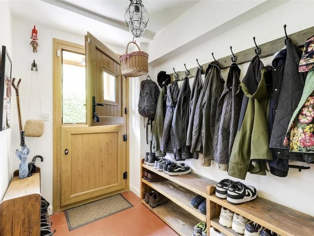 The boot room has quarry tiled flooring, a stable door opening to the side elevation, and access to the office.