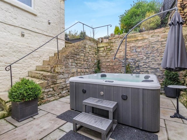 This photo shows how steps rise from a private sandstone patio to the main part of the garden.