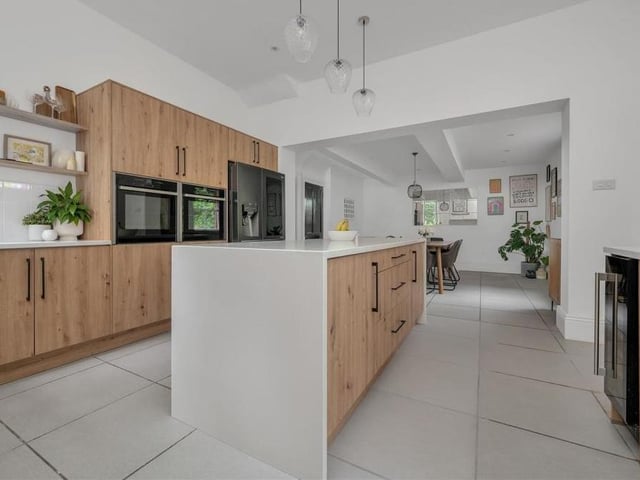 Moving into the bright and contemporary, open-plan dining kitchen now. It is fitted with a range of oak-style wall-cupboards, base units and drawers, complemented by quartz worktops.