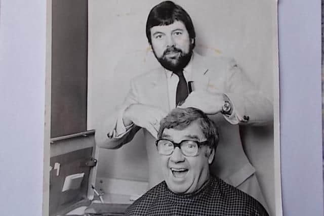 Barber Roger Brown cutting the hair of comedian Frank Carson
