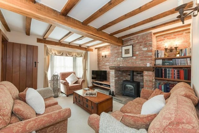 The cosy snug is a super, little space. Look at its exposed beams, as well as its fireplace and oak flooring.