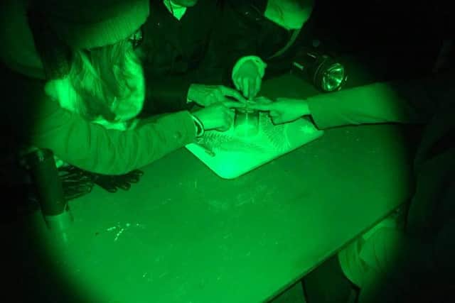 The Village, Mansfield, a paranormal events venue for hire for all. Ghost hunters use a glass to summon spirits.