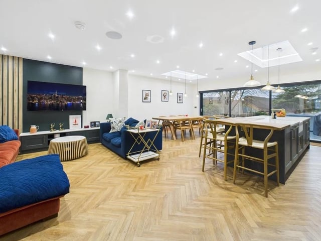 The heart of the home is the impressive open-plan living, dining, and kitchen space.