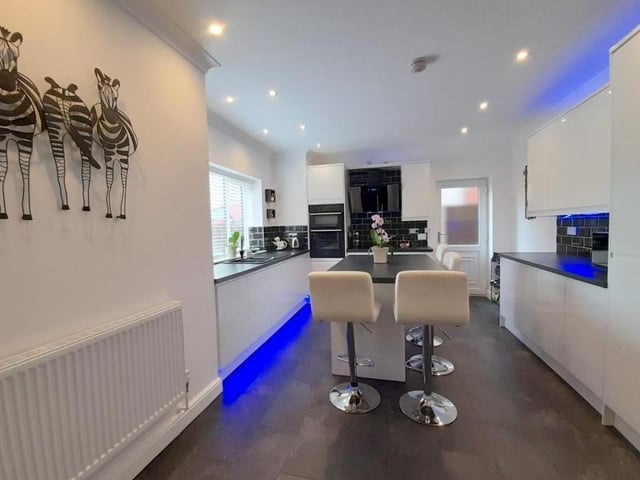 As you can see, the kitchen is not only contemporary, it is also bright and light. Next door is a utility room with plumbing for a washing machine.