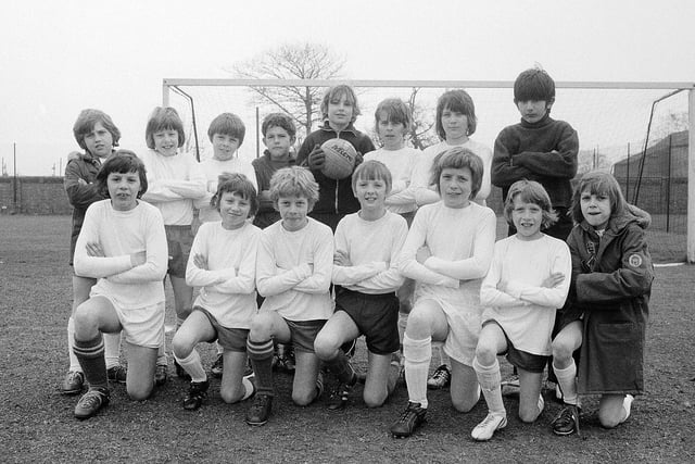 This junior football team proudly pose in their perfect white kits back in 1973. Is this you in your youth?
