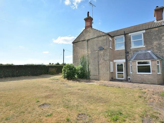 A view of the side of the house, with the dining room in the foreground.