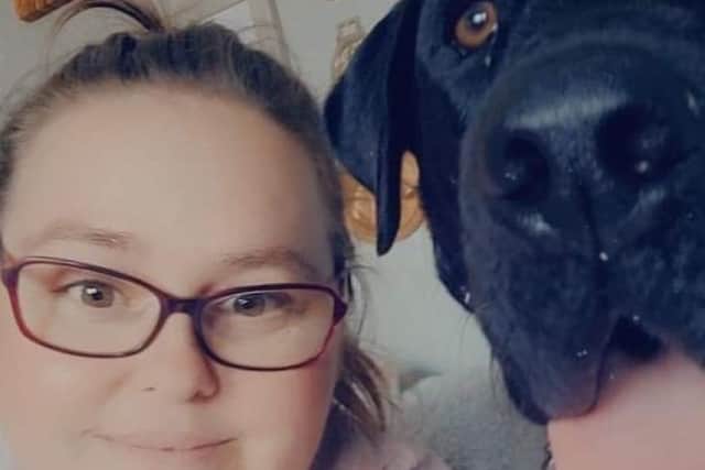 Sammy volunteers alongside Sarah at the food bank. Sammy is pictured with her dog, Dexter.