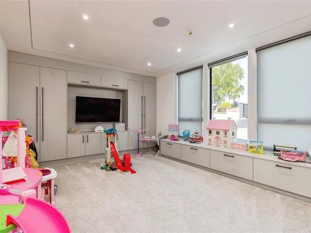 An additional fifth bedroom located on the ground floor is currently used as a playroom.