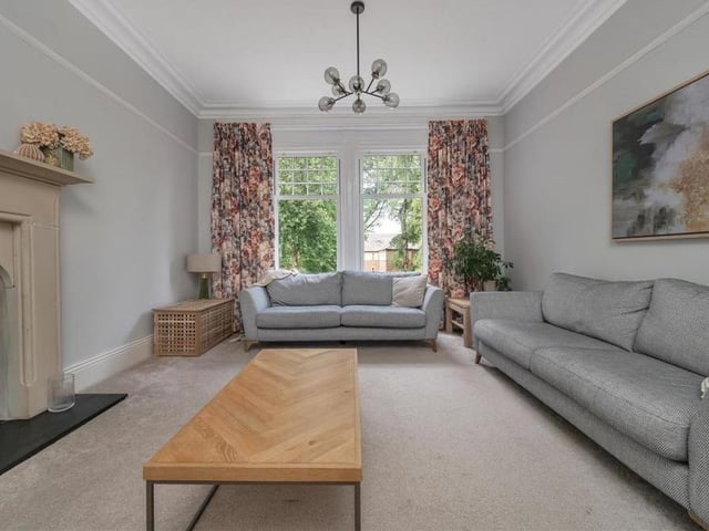 Another view of the lounge, which overlooks the front garden via two floor-to-ceiling, double-glazed windows.