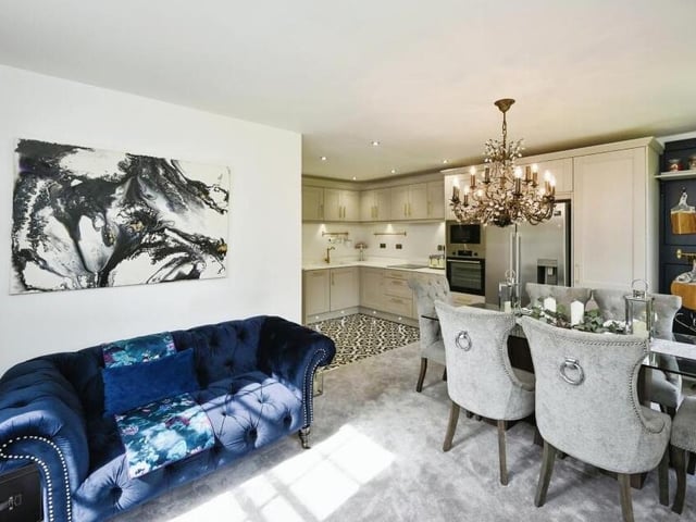The open-plan area of the apartment, which is ideal for relaxing or for entertaining guests, boasts a plush living space, with tasteful decor.