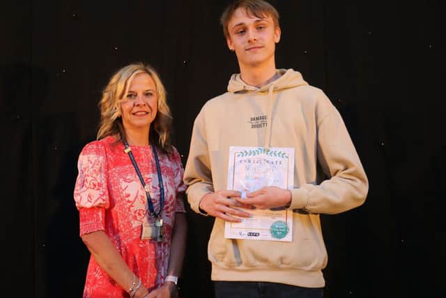 Vice principal Diane Booth presents Edward Walters with his principal's award