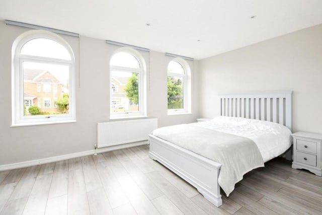 The large master bedroom is distinguished by these three eyecatching windows, overlooking the front, which are also so visible from the street and give the Carisbrooke Close property a unique look.