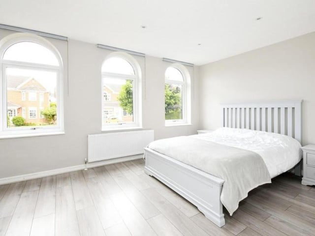 The large master bedroom is distinguished by these three eyecatching windows, overlooking the front, which are also so visible from the street and give the Carisbrooke Close property a unique look.