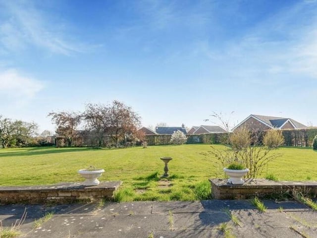 The last photo in our gallery shows the view from the paved seating area at the back of the £580,000 bungalow.