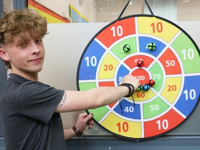 Mak Riley scoring a bullseye on the darts game.