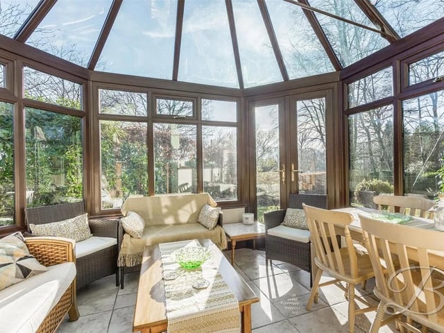 A light filled space with an ambiance of natural daylight, space for ample furniture and patio doors opening to the side.